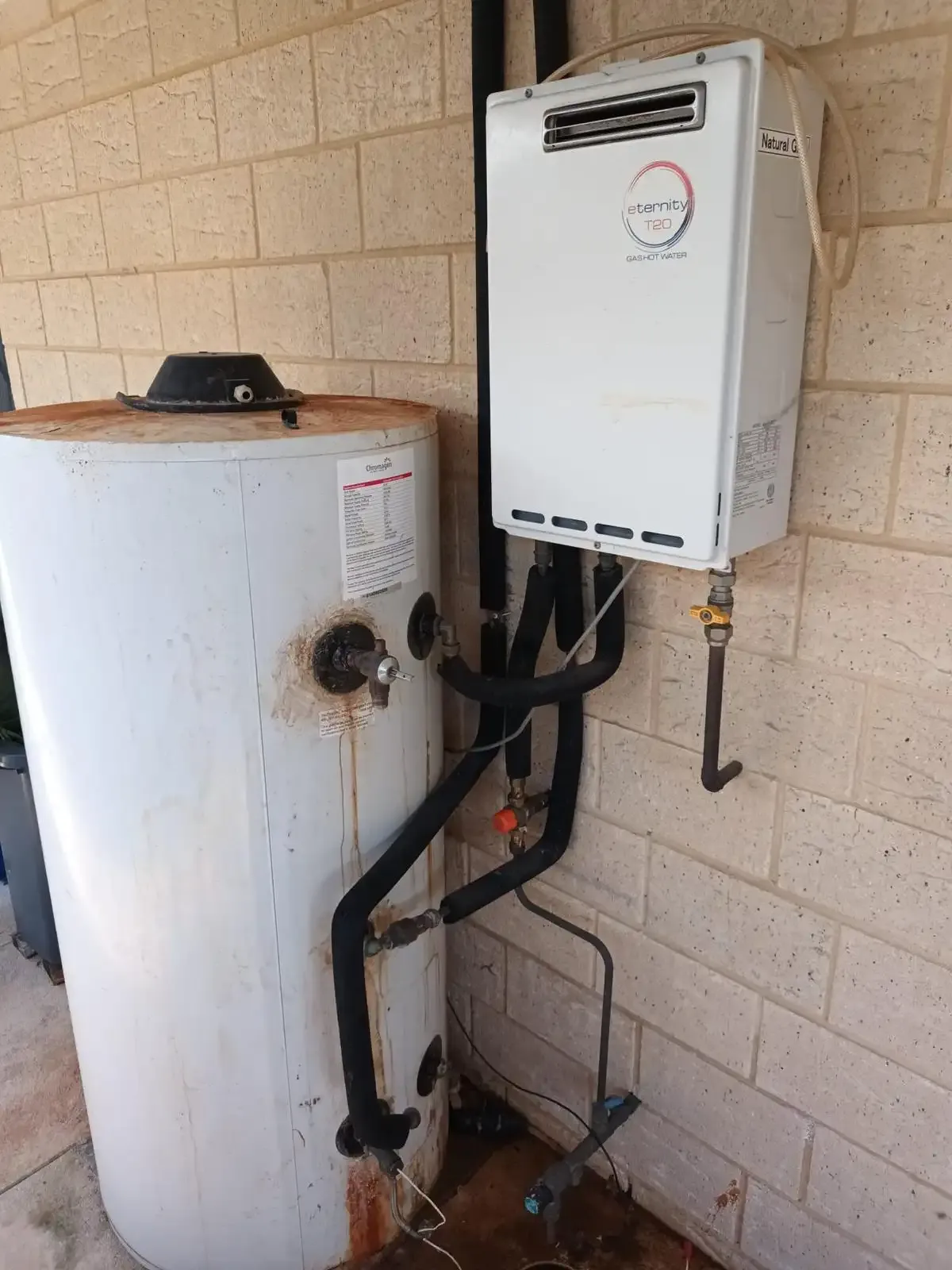 A gas continuous flow hot water unit with its natural gas isolation valve.